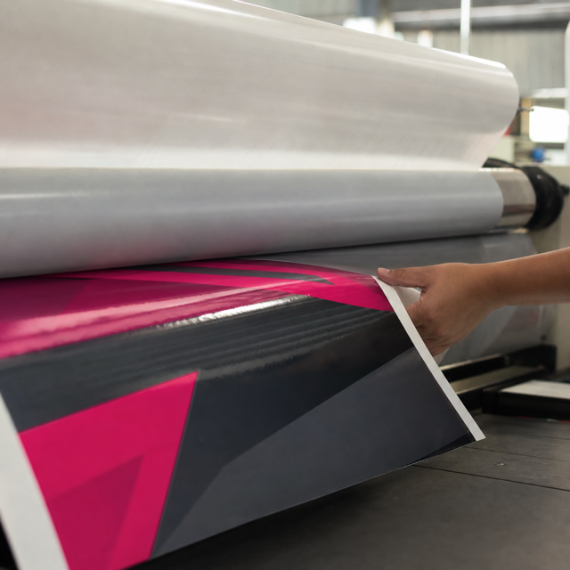 Printed lorry sticker vinyl passing through the laminator for its UV protective layer